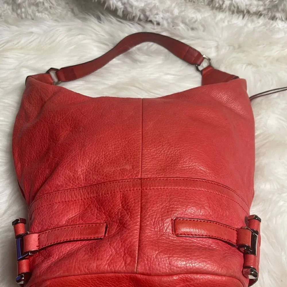 B Makowsky leather orange Hobo bucket style shoulder bag  silver tone hardwares